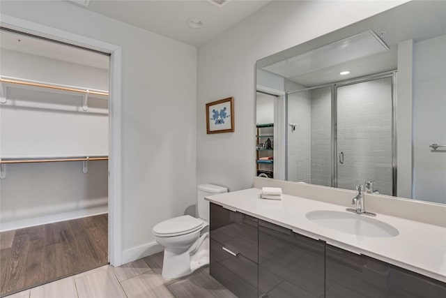 1800 E 4th St Unit 337, Austin, TX 78702 - full bathroom with a walk in closet, vanity, toilet, a shower stall, and recessed lighting