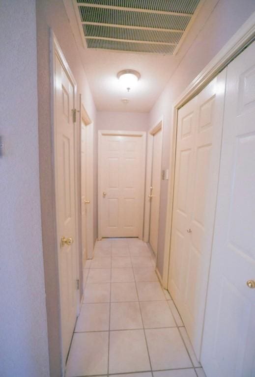 corridor with light tile patterned floors