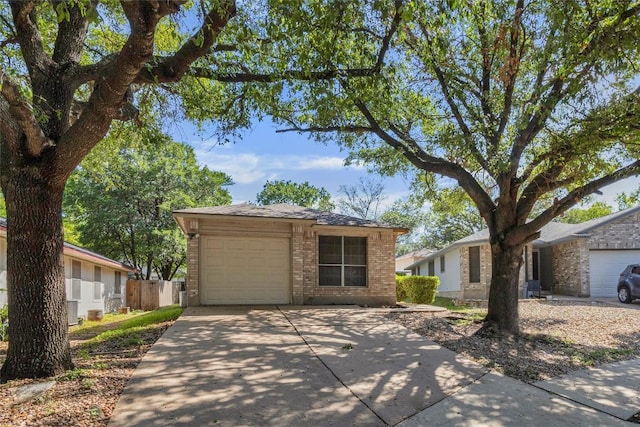 9145 Swanson Ln, Austin, TX 78748 - single story home with brick siding, an attached garage, fence, and concrete driveway