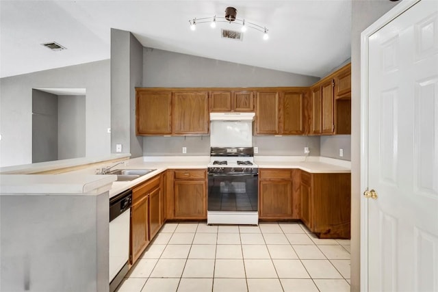 9145 Swanson Ln, Austin, TX 78748 - kitchen with brown cabinetry, white dishwasher, gas range, under cabinet range hood, and vaulted ceiling