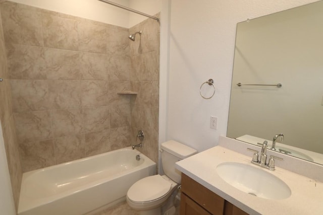 full bathroom featuring tiled shower / bath, vanity, and toilet