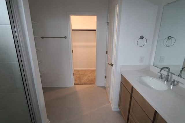 bathroom with vanity, tile patterned flooring, and a shower with door