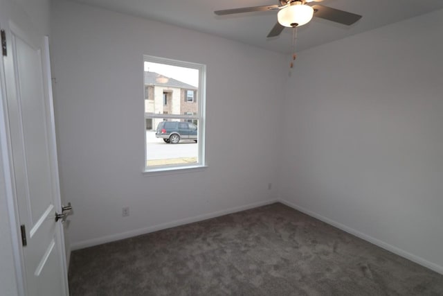 carpeted spare room featuring ceiling fan