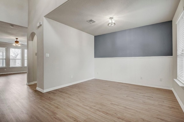 spare room featuring ceiling fan and light hardwood / wood-style flooring