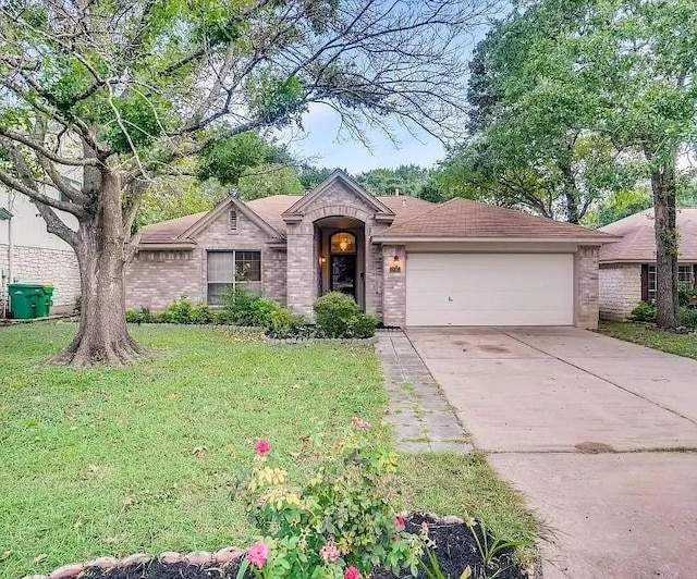 ranch-style house featuring a garage and a front lawn