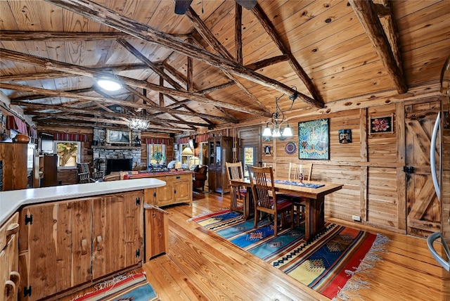 525 Plant Lady Ln, Dripping Springs, TX 78620 - dining room with wood walls, a notable chandelier, wooden ceiling, and light wood-style flooring