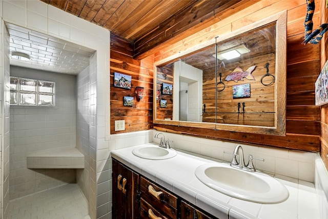 525 Plant Lady Ln, Dripping Springs, TX 78620 - full bathroom featuring double vanity, wooden ceiling, a sink, and wooden walls