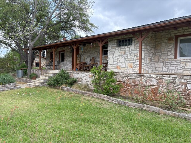 525 Plant Lady Ln, Dripping Springs, TX 78620 - exterior space with a front lawn, stone siding, and covered porch