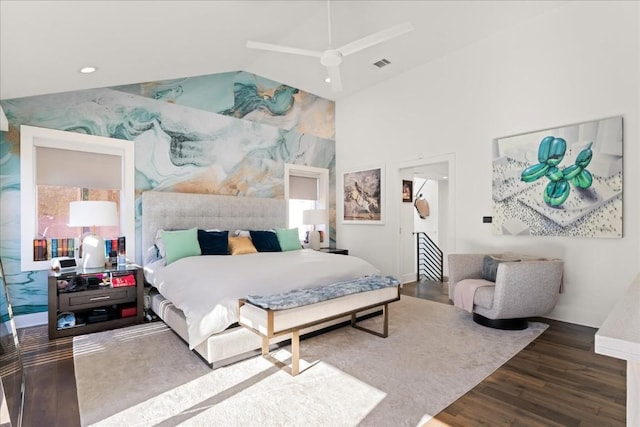 bedroom with hardwood / wood-style flooring and high vaulted ceiling