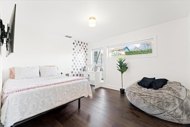 bedroom with dark hardwood / wood-style flooring