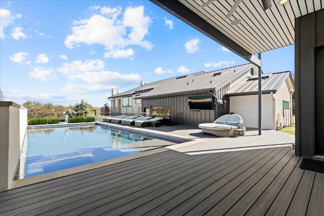 view of pool with outdoor lounge area and a deck