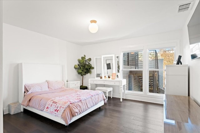 bedroom with dark hardwood / wood-style flooring