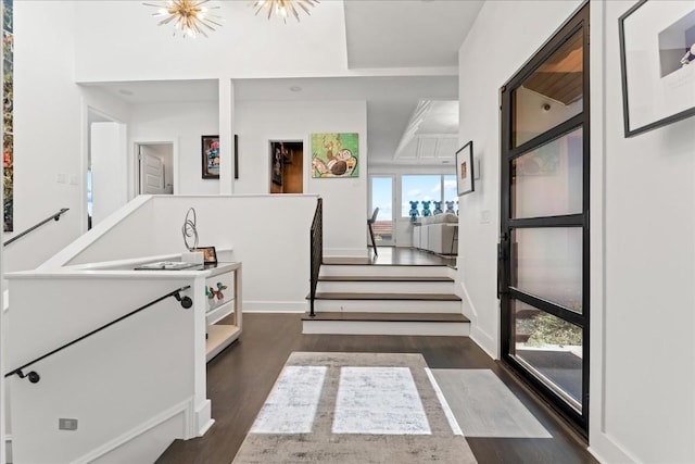 hallway featuring a notable chandelier and dark wood-type flooring