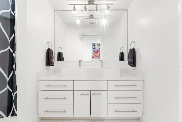 bathroom featuring vanity and rail lighting