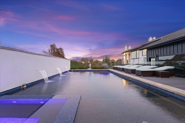 view of pool at dusk