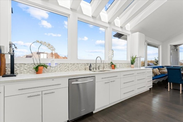 kitchen with dark hardwood / wood-style floors, dishwasher, sink, and white cabinets