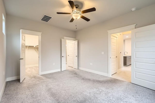 10610 Wills Loop, Austin, TX 78717 - unfurnished bedroom featuring light carpet, a walk in closet, and ceiling fan