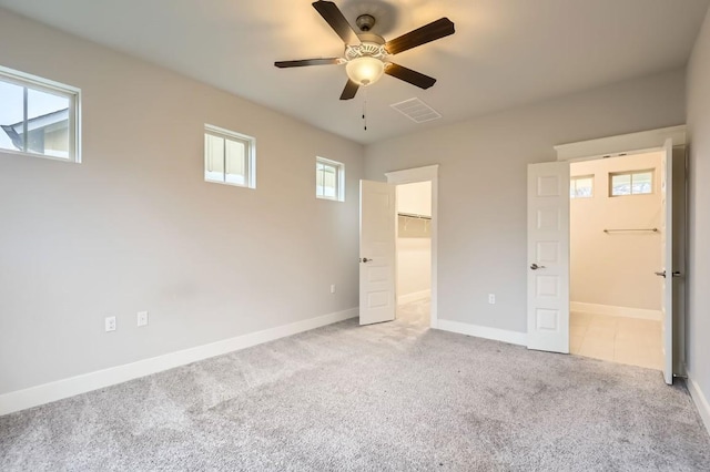 10610 Wills Loop, Austin, TX 78717 - unfurnished bedroom featuring carpet, a walk in closet, ceiling fan, a closet, and connected bathroom
