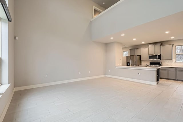 10610 Wills Loop, Austin, TX 78717 - unfurnished living room featuring recessed lighting and baseboards