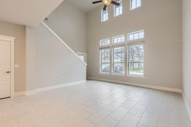 10610 Wills Loop, Austin, TX 78717 - unfurnished living room featuring ceiling fan, a towering ceiling, and stairway