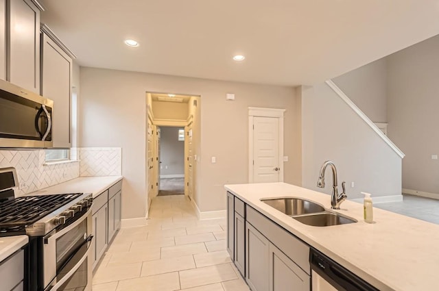 10610 Wills Loop, Austin, TX 78717 - kitchen featuring stainless steel appliances, light countertops, tasteful backsplash, recessed lighting, and gray cabinets