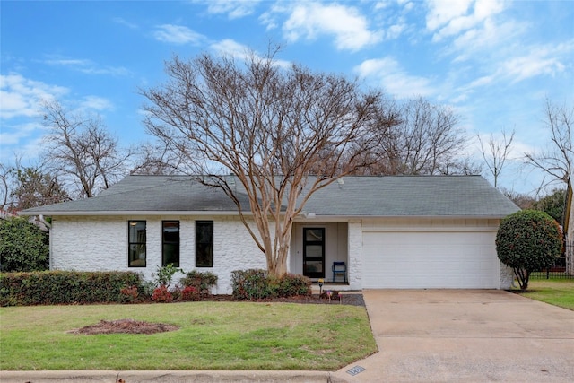 ranch-style house with a garage and a front yard