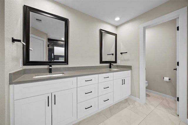 bathroom featuring vanity and toilet