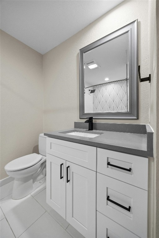 bathroom featuring vanity, walk in shower, and toilet