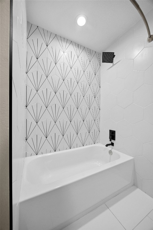 bathroom featuring tile walls and  shower combination