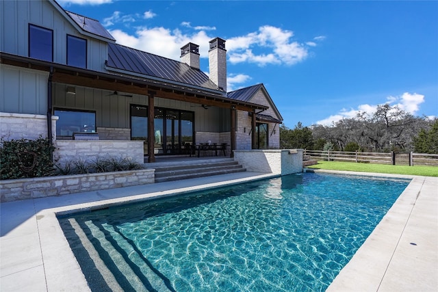 view of swimming pool featuring a patio area and ceiling fan