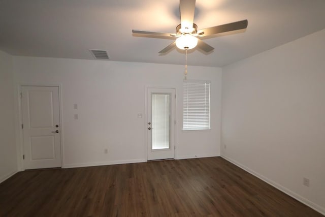 spare room with ceiling fan and dark hardwood / wood-style floors