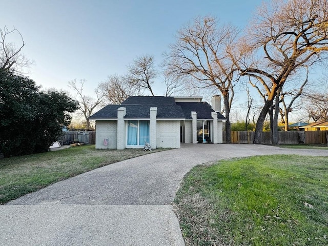 view of front of property featuring a garage and a front lawn