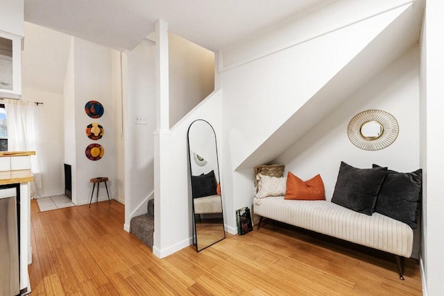 5608 Cougar Dr Unit 220, Austin, TX 78745 - sitting room featuring light wood-type flooring, stairway, and baseboards