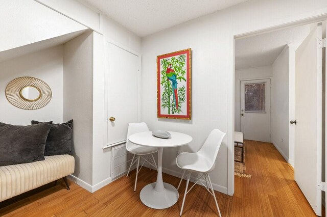 5608 Cougar Dr Unit 220, Austin, TX 78745 - dining area with light wood-style flooring and baseboards