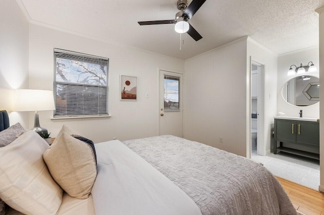 5608 Cougar Dr Unit 220, Austin, TX 78745 - bedroom with crown molding, light wood-style flooring, ceiling fan, and a sink