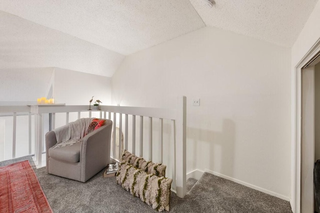 5608 Cougar Dr Unit 220, Austin, TX 78745 - living area with lofted ceiling, carpet, a textured ceiling, an upstairs landing, and baseboards