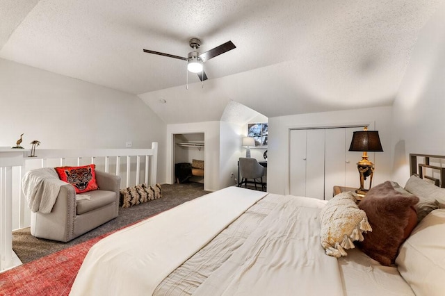5608 Cougar Dr Unit 220, Austin, TX 78745 - bedroom with multiple closets, vaulted ceiling, a textured ceiling, carpet, and a ceiling fan