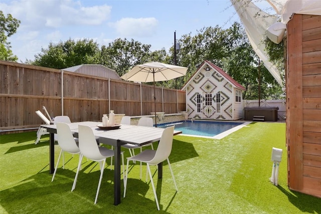 view of swimming pool featuring an outbuilding and a lawn