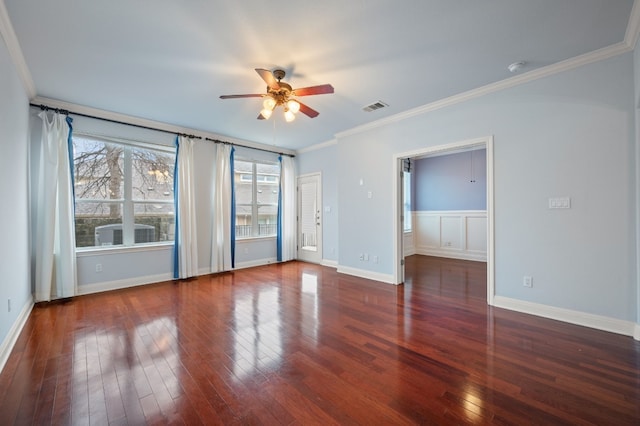 empty room with ceiling fan, dark wood-type flooring, and crown molding