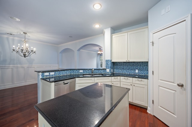 kitchen featuring dishwasher, pendant lighting, sink, white cabinetry, and kitchen peninsula