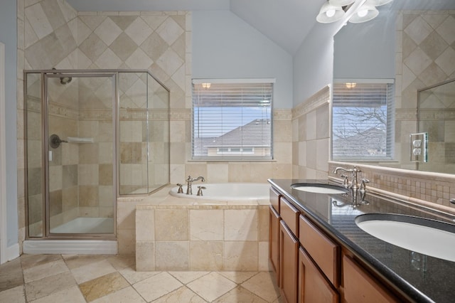 bathroom with separate shower and tub, lofted ceiling, tile walls, decorative backsplash, and vanity