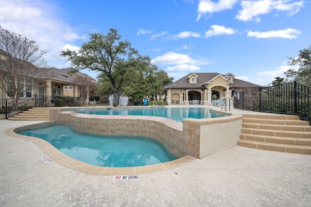 view of swimming pool with a patio