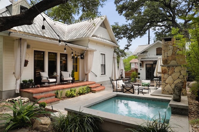 209 E Elizabeth St, Austin, TX 78704 - back of property with an outdoor pool, metal roof, and a patio