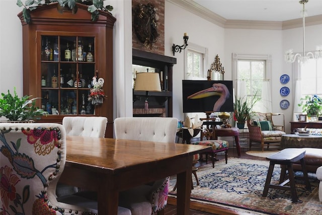 209 E Elizabeth St, Austin, TX 78704 - dining space featuring plenty of natural light, crown molding, wood finished floors, and a chandelier