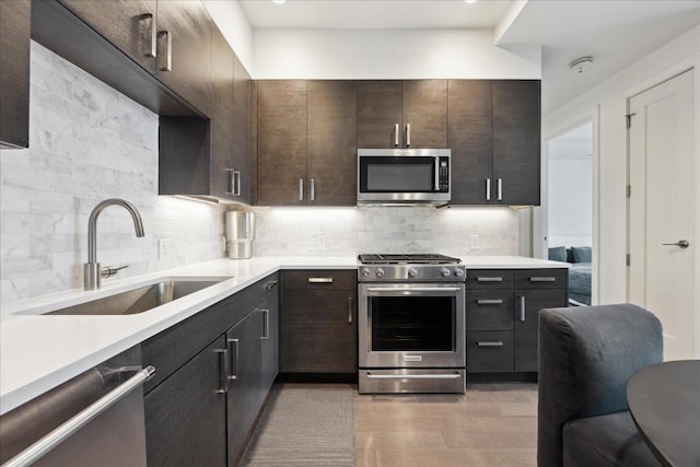 222 W Ave Unit 1312, Austin, TX 78701 - kitchen featuring stainless steel appliances, a sink, tasteful backsplash, and light countertops