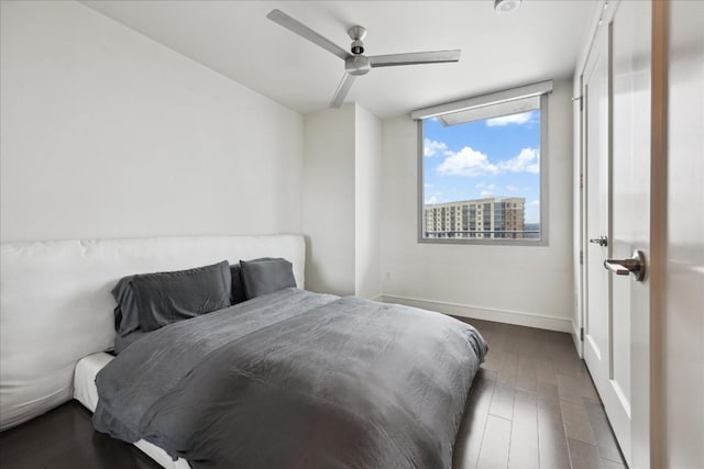 bedroom featuring ceiling fan and dark hardwood / wood-style floors