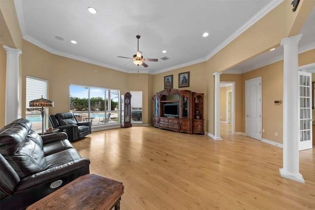 living room with ornate columns, crown molding, ceiling fan, and light hardwood / wood-style floors