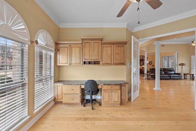 office featuring ceiling fan, built in desk, light hardwood / wood-style flooring, and ornate columns