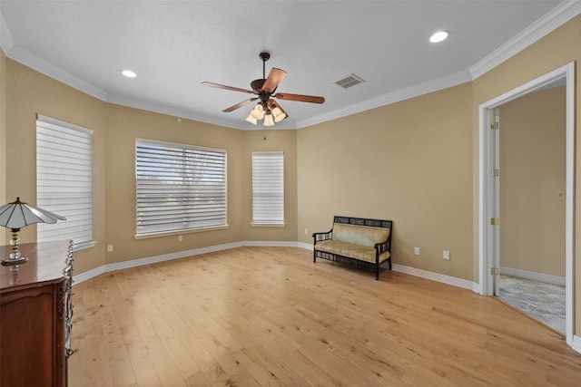 unfurnished room featuring crown molding, light hardwood / wood-style flooring, and ceiling fan