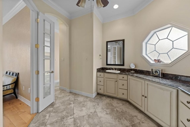 bathroom featuring vanity, ornamental molding, and ceiling fan